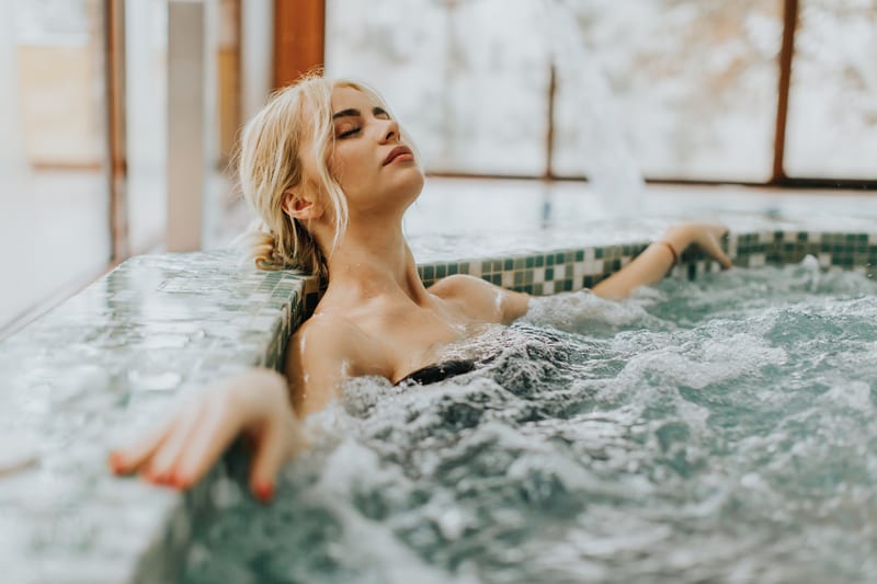 Young woman relaxing in hot tub